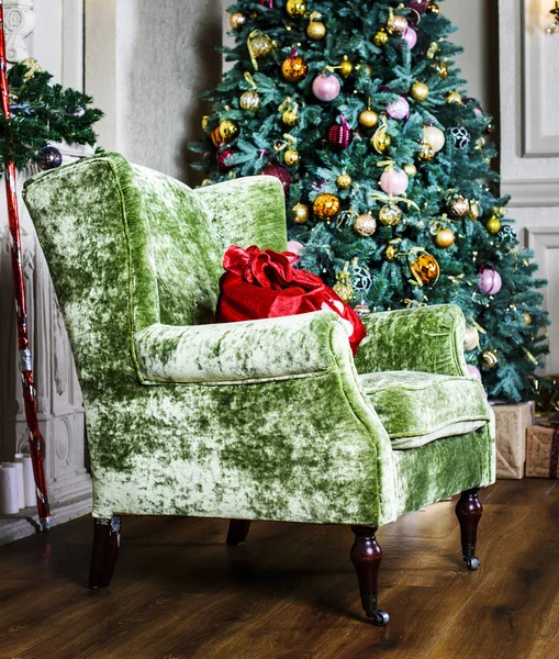 Beautiful chair and Christmas tree with gifts — Stock Photo, Image
