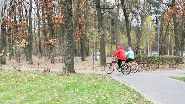 family bike ride in the autumn park.