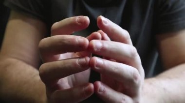 Close view of male hands with strongly bitten nails. Finger selection with alarm. Ugly bitten fingers, cuticles, wounds on the fingers. Bad habit. The concept of onychophagy and dermatophagy.