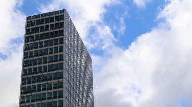 Dusseldorf, Germany - February 20, 2020: modern glass building. Windows of a skyscraper with blue sky, Corporate building in the city. Exterior glass wall of a skyscraper of a tall building.