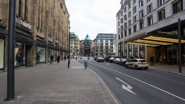 Dusseldorf, Germany - February 20, 2020: city and shopping streets around Dusseldorf. Street scenes and parked cars on the street. Modern commercial architecture and residential buildings in Germany