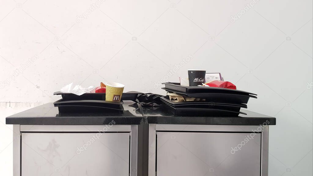 Ukraine, Kiev - March 06, 2020. The concept of cleanliness and cleaning rules. At the exit of fast food, a McDonald's trash can with trays