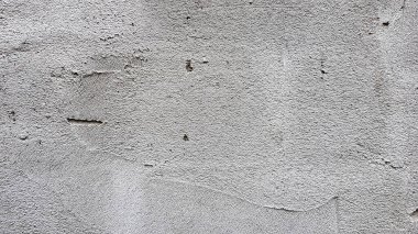 Gri bir beton duvarın içi. Sıva dokusu. Kaba bir şekilde arka planda gri bir leke var. Beton alçı. Desen Ayrıntıları Boş Boşluk Makro Kapatma.