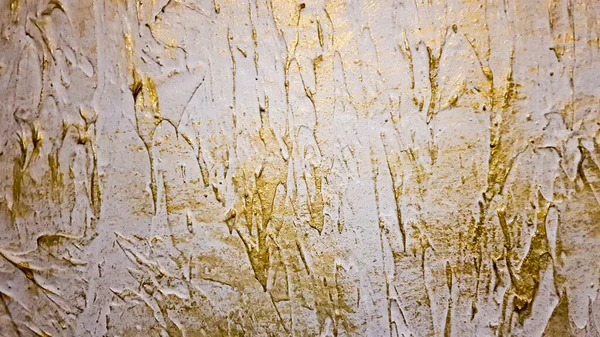 White with gold concrete wall texture or grunge style background. Gold texture background ,cement wall. Old gold plaster wall texture yellow background