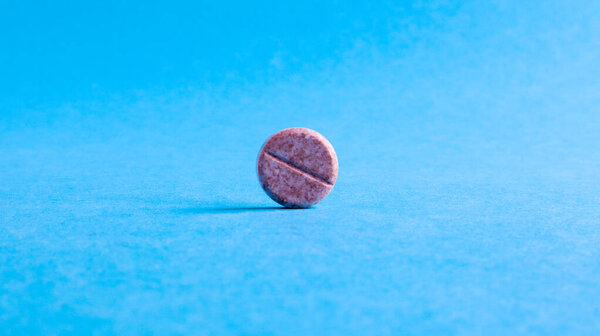 One round small pill on a blue background in the center with empty space for text