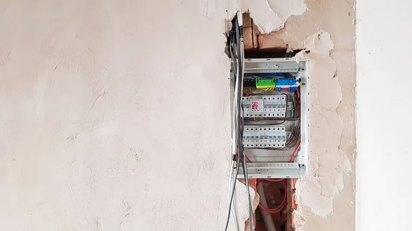 Electrical safety in homes, switchboard panel with switches. Home electrical system in the apartment under repair. Circuit breakers with wires in an electric screen with copy space