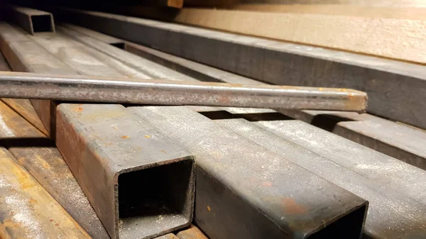 Square high carbon metal pipe at a construction site
