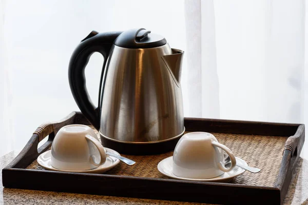 Electric kettle and coffee cup set in hotel room, ceramic cup set,