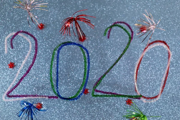 2020 New Years postcard with festive multicolored pipe cleaners.