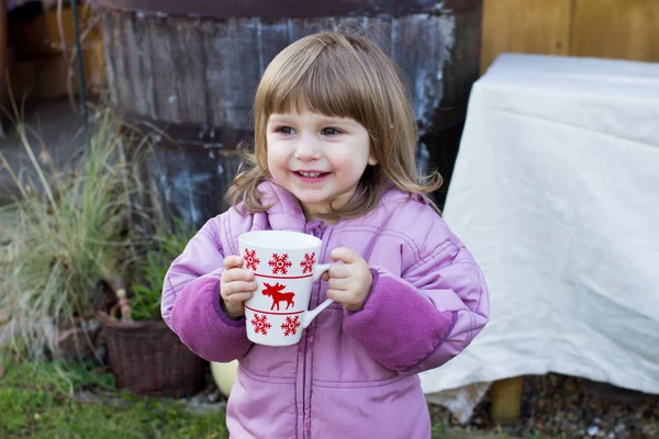 Child girl with a cup of tea — Stock Photo, Image