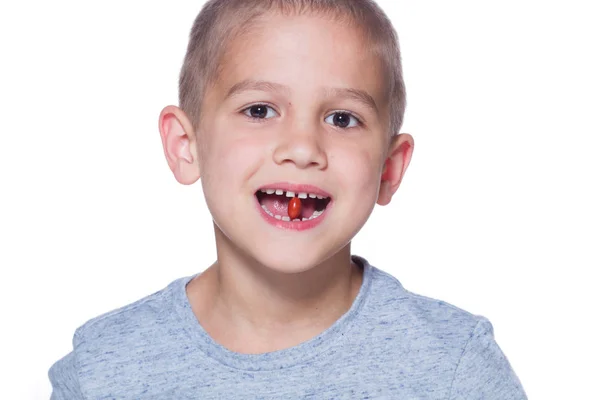 Boy eating a tablet of vitamin — Stock Photo, Image