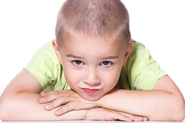 A boy is laying his head on hands — Stock Photo, Image