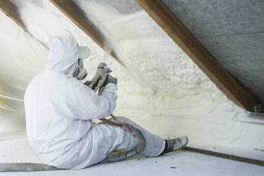 spray polyurethane foam for roof - technician spraying foam insulation using plural component gun for polyurethane foam, inside clipart