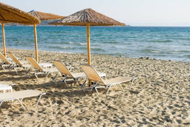 Şemsiyeli boş plaj ve boş güneşlikler.