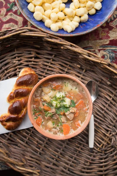 Traditional food, goulash soup with fresh scone — Stock Photo, Image