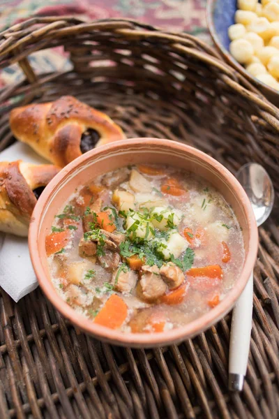Traditional food, goulash soup with fresh scone — Stock Photo, Image