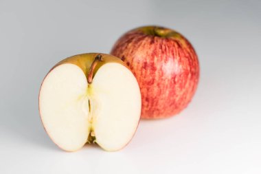 Beyaz parlak mutfak masasında su damlacıkları olan taze kırmızı çizgili elmalar. Lezzetli, sulu meyveler. Sağlıklı yeme izole nesne