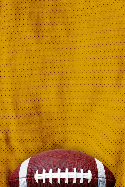 Yellow American Football Jersey textured with a football on a horizontal view — 스톡 사진