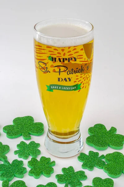 St patrick\'s days Beer Pint with a green hat and clovers around