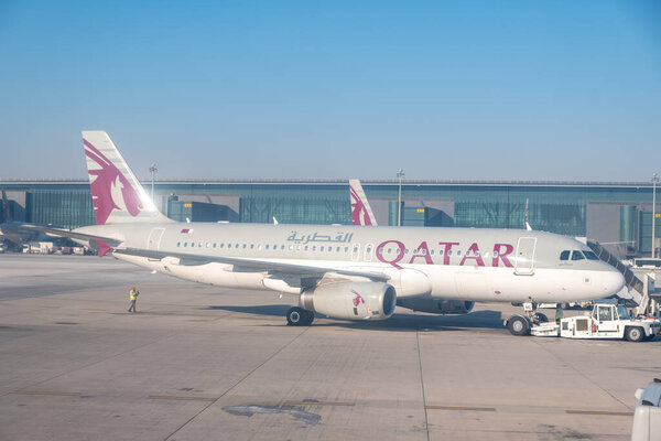 DOHA, QATAR -MARCH 2020- View of an airplane from Qatar Airways (QR) at the Hamad International Airport (DOH) in Doha.