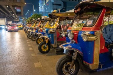 Bangkok, Thailand - February 2020; Famous moto-taxi called tuk-tuk is a landmark of the city and popular transport, Tuk tuk on the street. Colorful legendary tuk-tuk taxi on the streets of Bangkok,