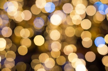 Turuncu ve sarı çözülmüş bokeh ışıkları. Tasarım için festival arka planında bulanık elektrik ampulleri