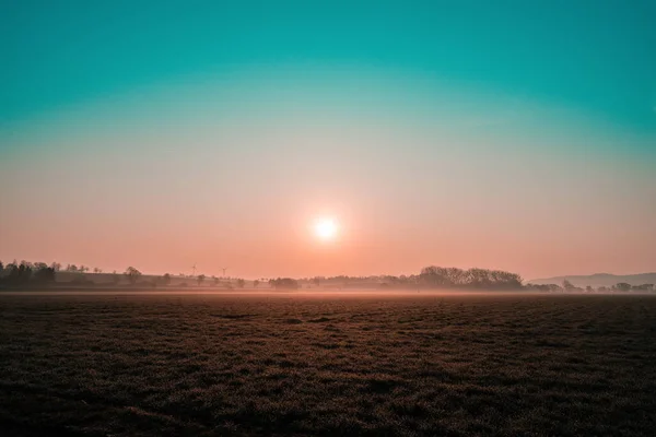 Colorful sunrise on the wide field — Stock Photo, Image