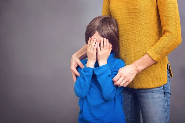 Sad little child, boy, hugging his mother at home, isolated imag — Stock Photo, Image