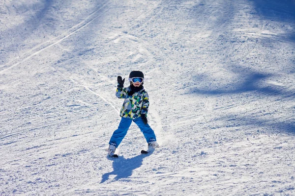 Söt liten pojke, skidåkning glatt i österrikiska skidorten i mo — Stockfoto