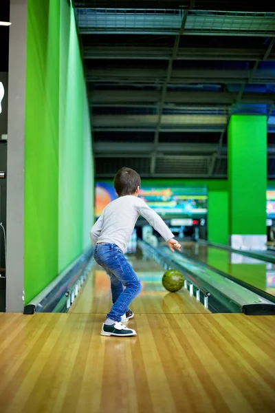 Young boy, playing bowling indoors — Stock Photo, Image