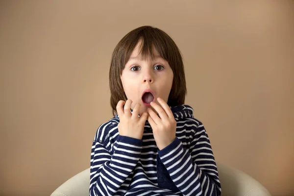 Menino pré-escolar doce, fazendo rostos com emoções diferentes — Fotografia de Stock