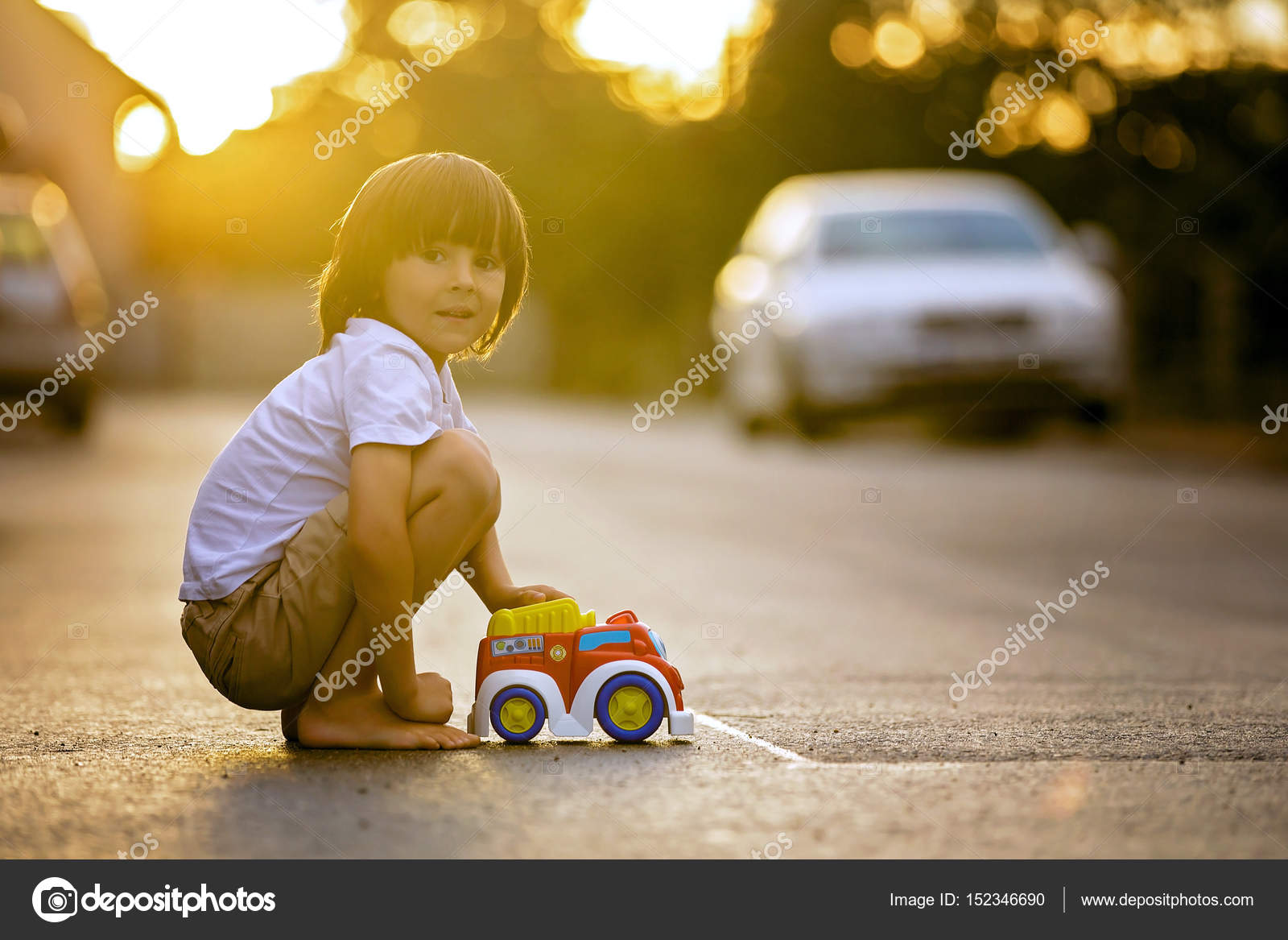 Two sweet children, boy brothers, playing with car toys on the s Stock ...