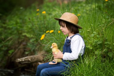 Ördek yavrusu ile little Nehri üzerinde oynayan tatlı çocuk