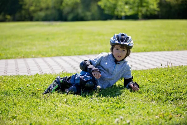 Mignon petit enfant, garçon, chevauchant sur un roller dans le parc — Photo