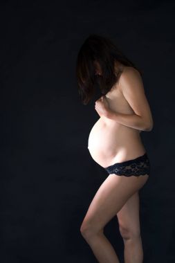 Portrait of Beautiful pregnant woman, isolated on black studio b clipart