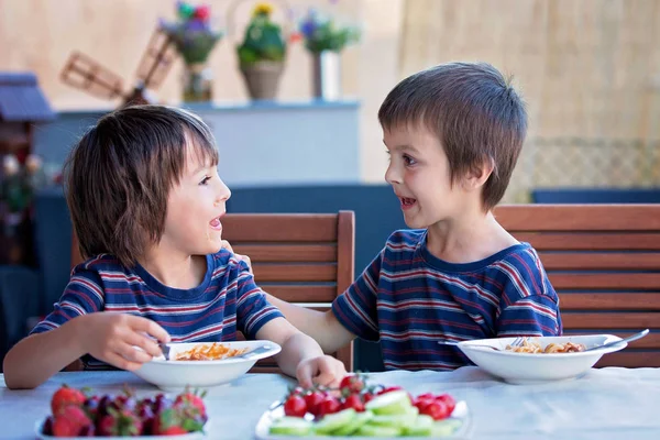 Söta barn, förskola pojkar, äta spaghetti för lunch oc. — Stockfoto