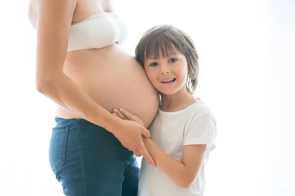 Portrait of beautiful pregnant woman and her cute child, isolate — Stock Photo, Image