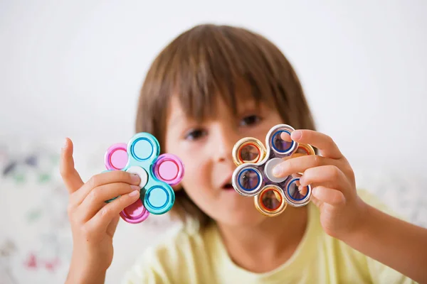 Young boy play with fidget spinner stress relieving toy — Stock Photo, Image