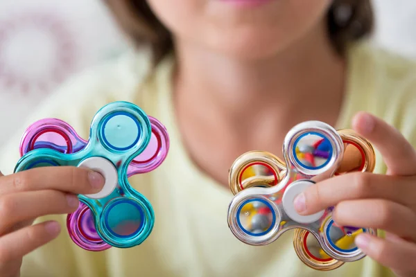 Young boy play with fidget spinner stress relieving toy — Stock Photo, Image