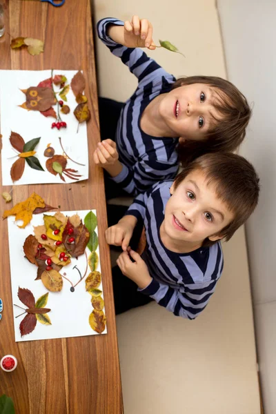 Sweet children, boys, applying leaves using glue while doing art — Stock Photo, Image