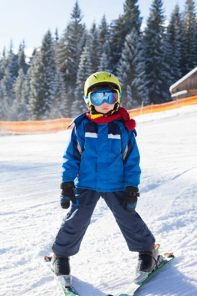 Симпатичный маленький мальчик, счастливо катается на лыжах в австрийском горнолыжном курорте в мо — стоковое фото