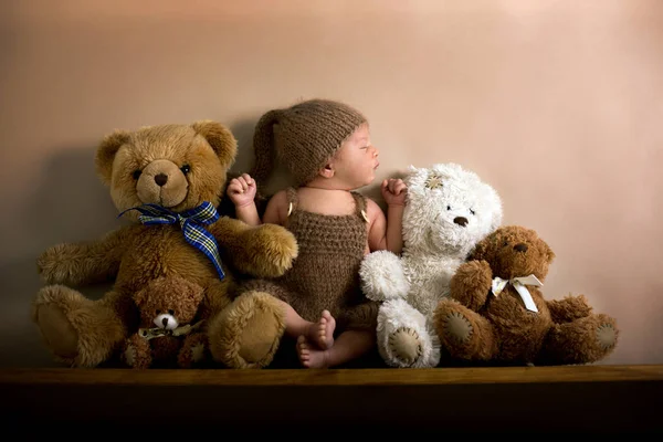 Newborn baby boy wearing a brown knitted bear hat and pants, sle