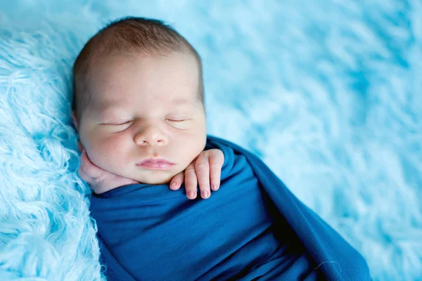 Bayi laki-laki yang lucu, tidur dengan damai dibungkus dengan bungkus biru — Stok Foto