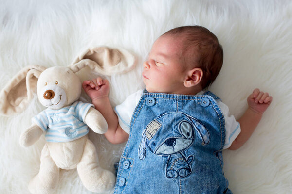 Fashionable little newborn baby boy, sleeping in the afternoon a Stock Photo