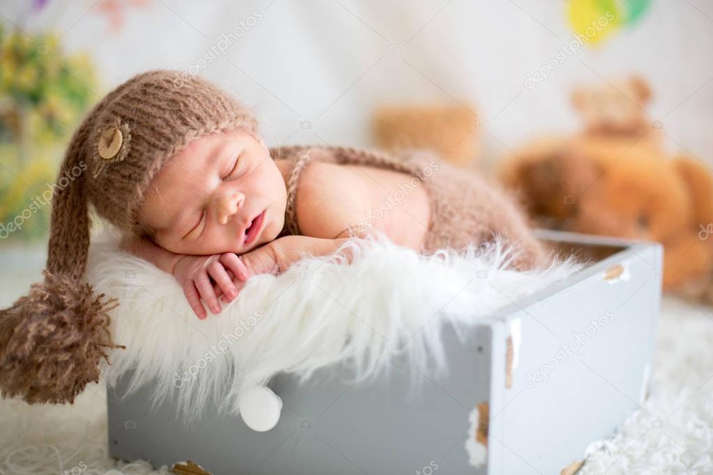 Cute newborn baby sleeps with a toys