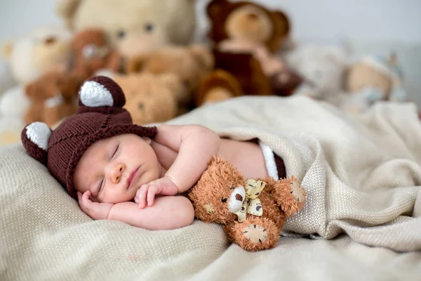 เด็กน้อยที่เกิดใหม่ นอนกับหมีเท็ดดี้ที่บ้านบนเตียง — ภาพถ่ายสต็อก