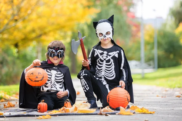 Two children, boy brothers in the park with Halloween costumes — Stock Photo, Image