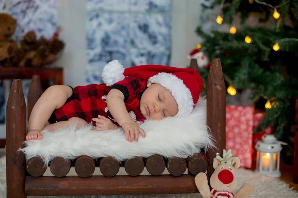 Portrait of newborn baby in Santa clothes in little baby bed, sl — Stock Photo, Image
