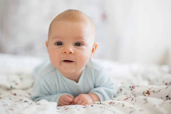 Adorable baby boy in white sunny bedroom in winter morning — Stock Photo, Image