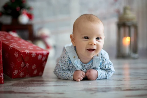 Cute christmas portrait of little baby boy, lying on his belly o — Stock Photo, Image
